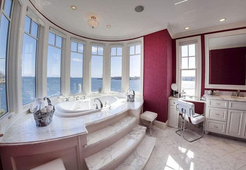 Traditional master bathroom with step up bathtub with ocean views
