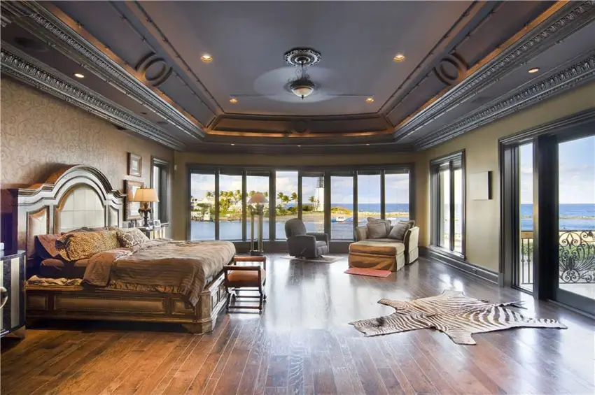 Traditional master bedroom with expansive ocean views carmel oak wood flooring and tray ceiling