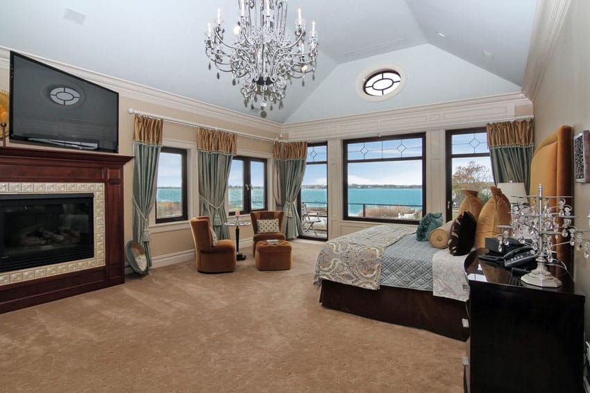 bedroom with lake views and gas fireplace