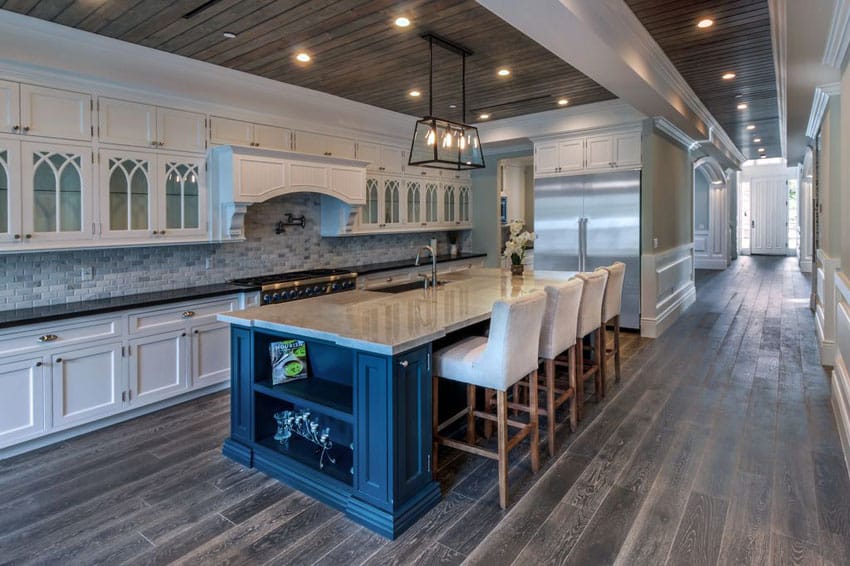 Galley kitchen with gray oak floors and carrara marble dining island