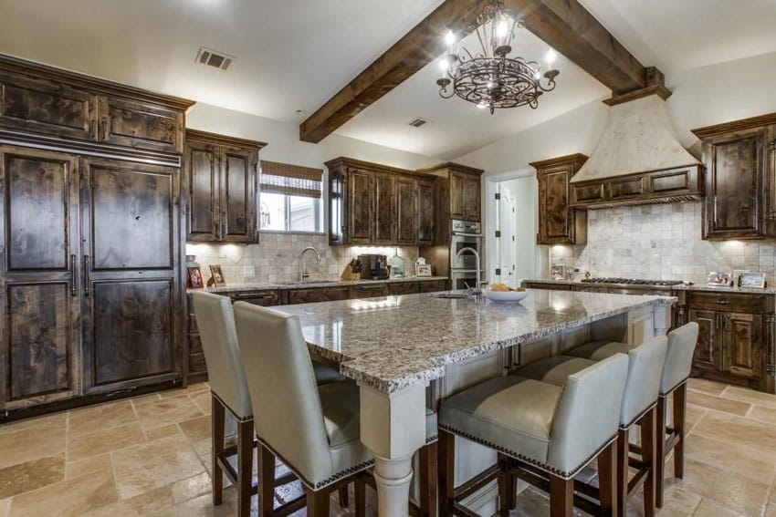 Traditional wood cabinet kitchen with large granite topped dining island