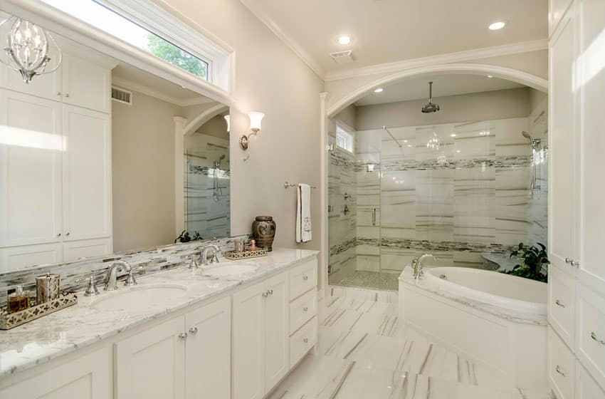 Transitional bathroom with frameless shower marble counters and crown molding