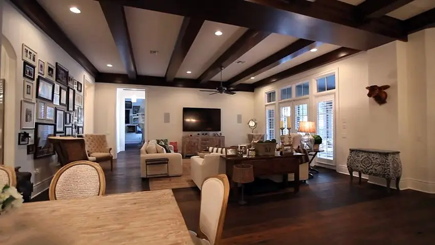 Transitional living room with hardwood flooring and open beams