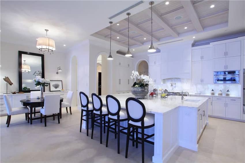 Kitchen with Shaker style cabinetry, white island bar and coffered kitchen ceiling