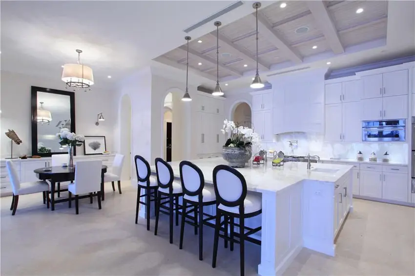 Kitchen with Shaker style cabinetry, white island bar and coffered kitchen ceiling