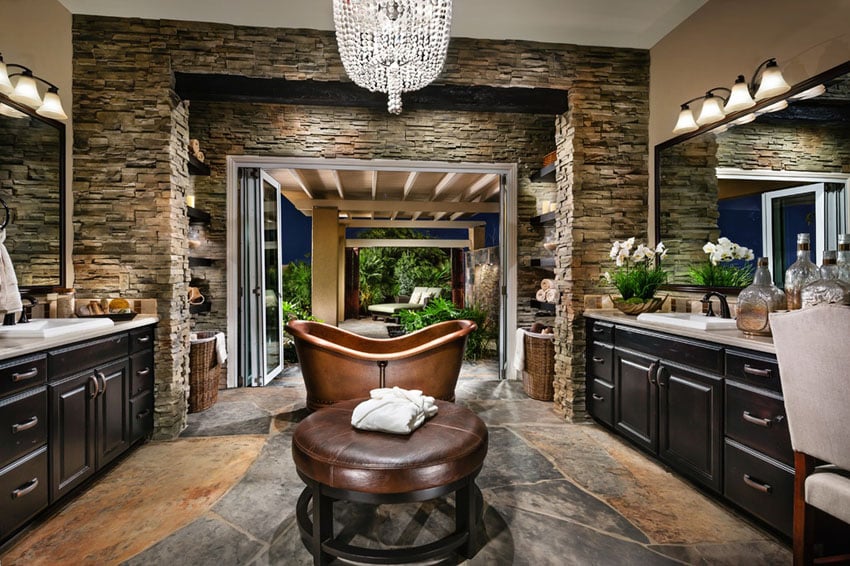 Upscale bathroom with copper bathtub and glass chandelier