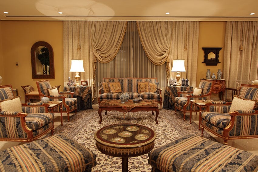 Well appointed luxury living room with matching furniture pieces and floral pattern area rug