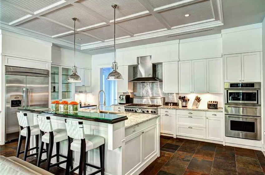 Kitchen with raised glass bar, Shaker style cabinets and slate floor tiles