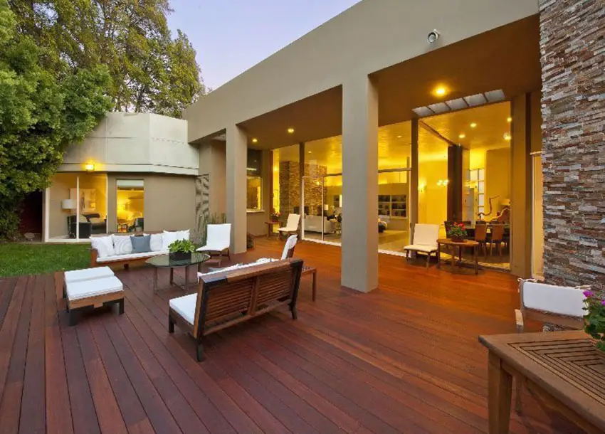 Wood deck at modern home with cushioned wood furniture