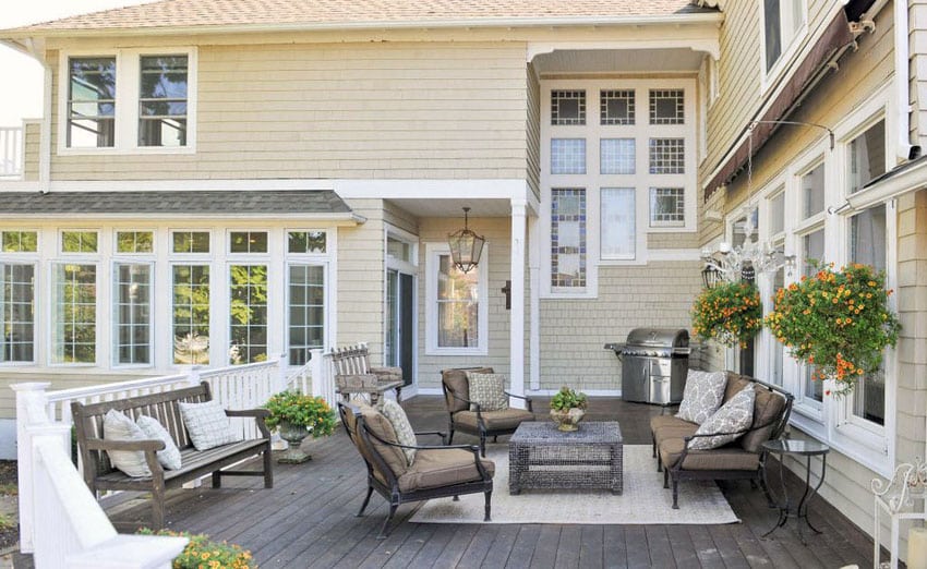 Wood deck at traditional home with white railing and wood benches