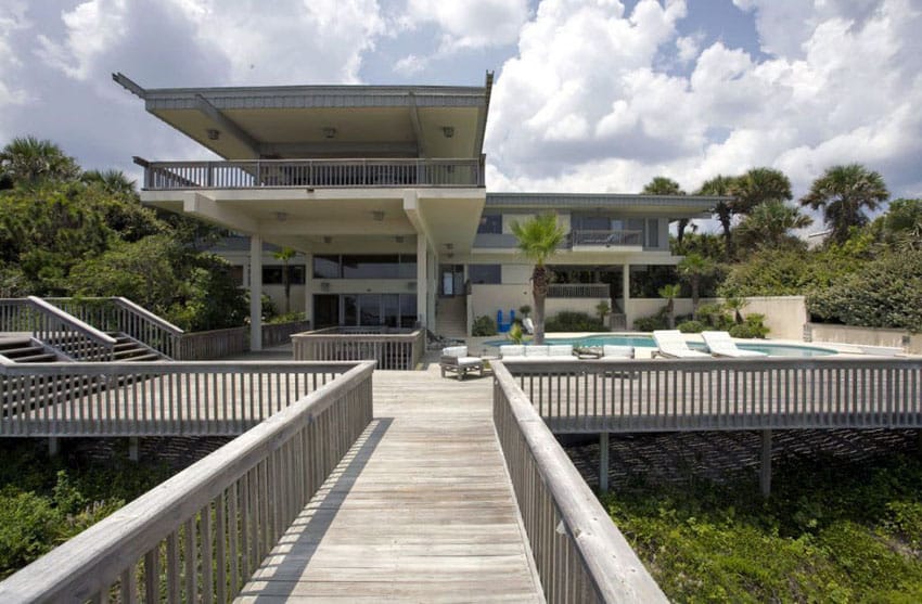 Wood deck in backyard of modern home with pathway