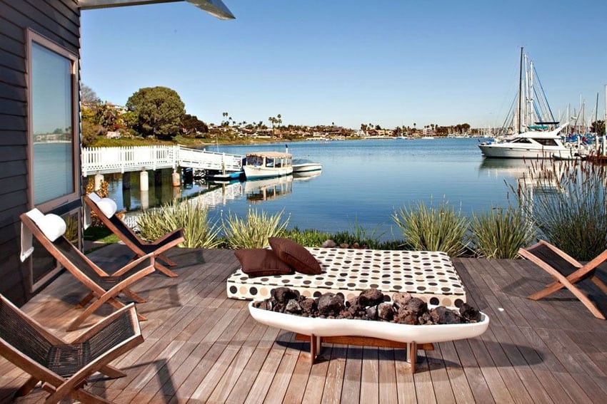 Wood deck overlooking bay with day bed