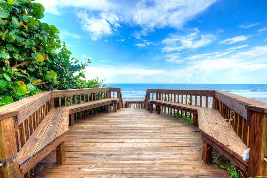 Wood deck with sitting benches leading to ocean