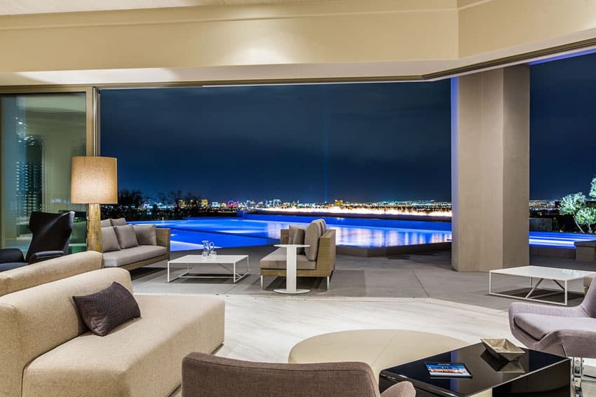 Amazing living room with large open view to patio swimming pool and city lights