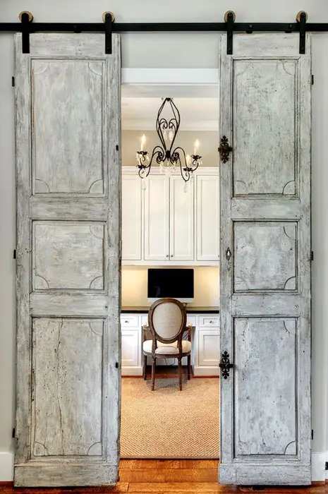 Antique french sliding barn doors leading to home office
