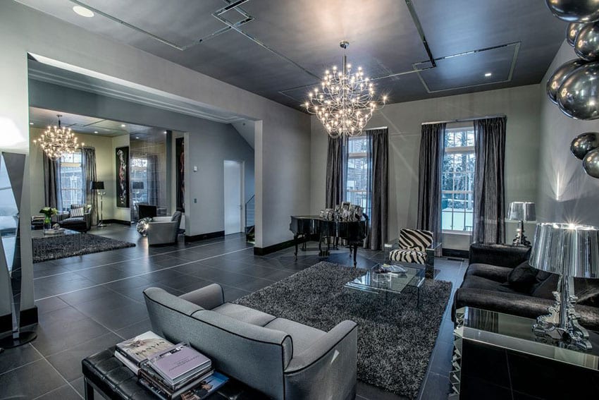 Art deco living room with dark theme porcelain tile floor, shag rug and modern chandelier