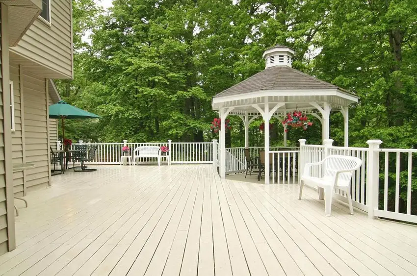 Backyard deck with white gazebo with seating