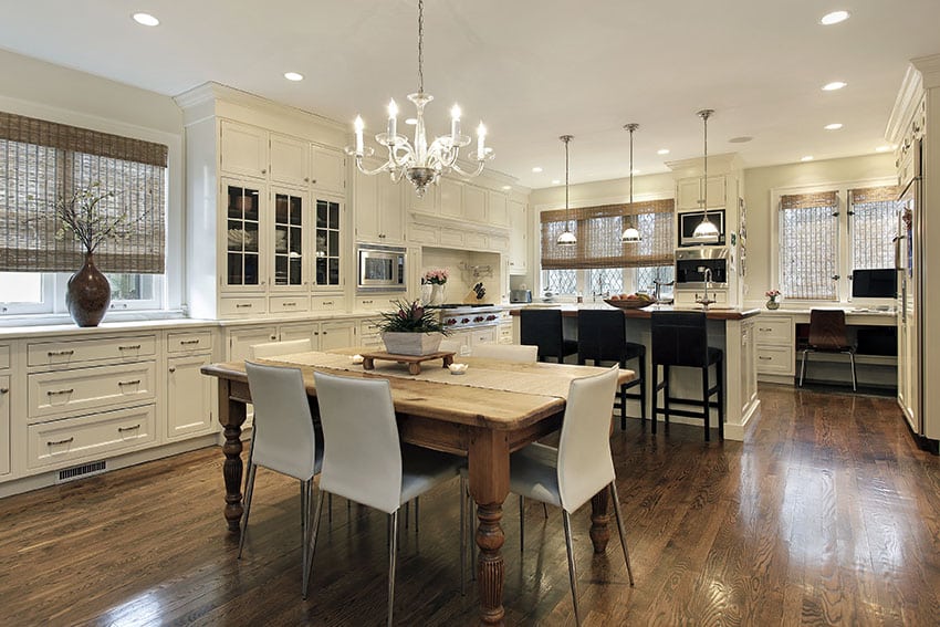 Kitchen with open layout, Shaker style cabinetry, chandelier and pendant lights