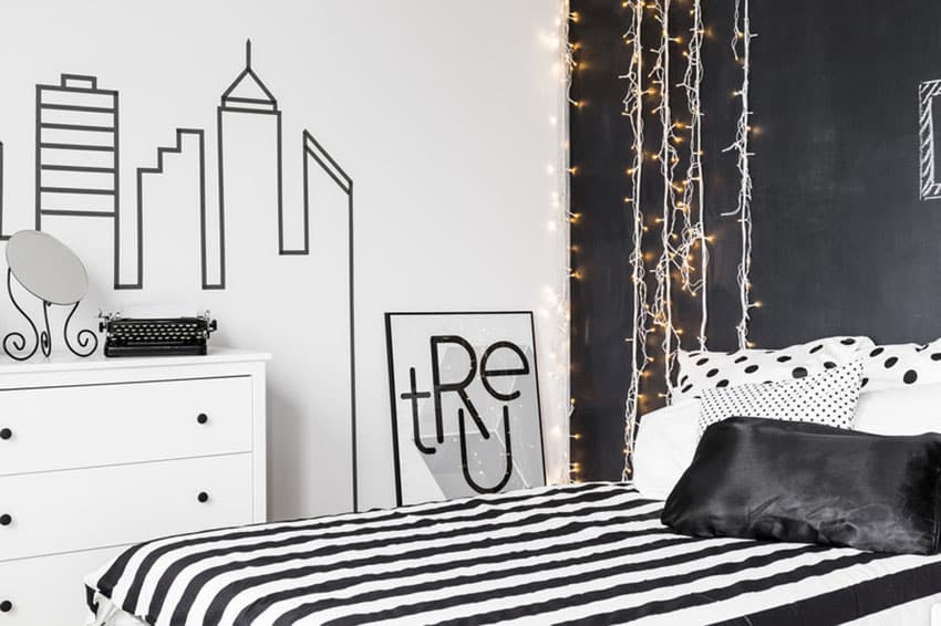 Black and white bedroom with matching bed cover and hanging lights