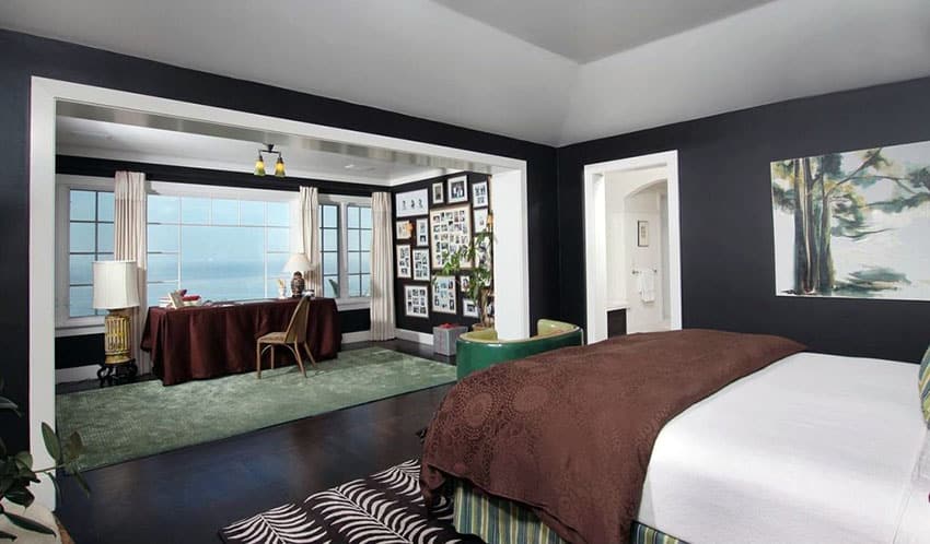 Black bedroom with picture window view of lake