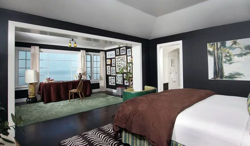Black bedroom with picture window view of lake
