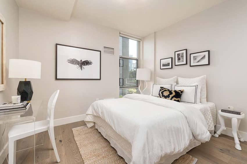 Bright guest bedroom with white furniture 