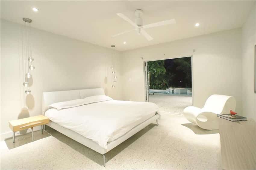 Bright white modern master bedroom with hanging lights