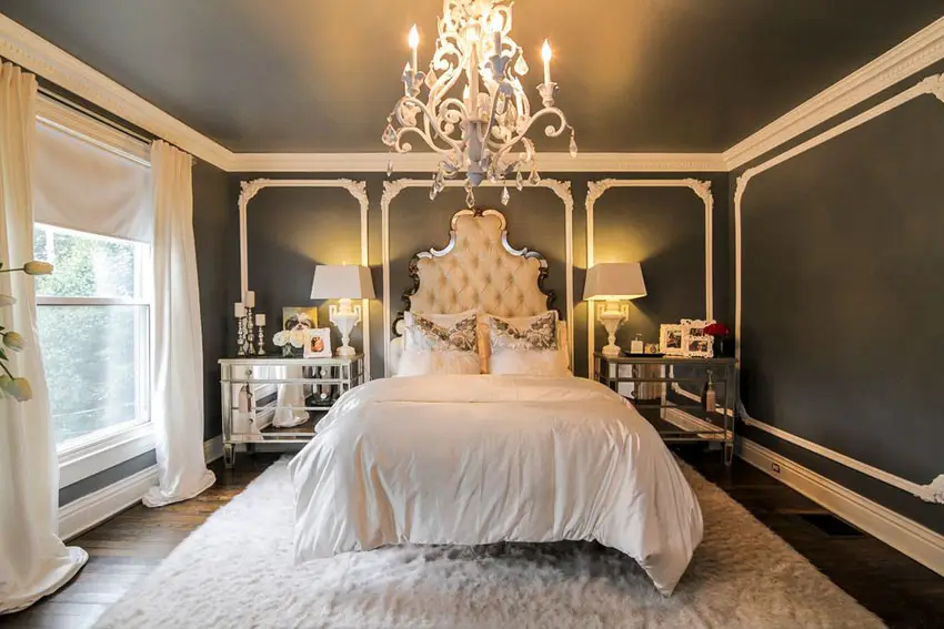Chic bedroom with black accent walls and cream tufted bed