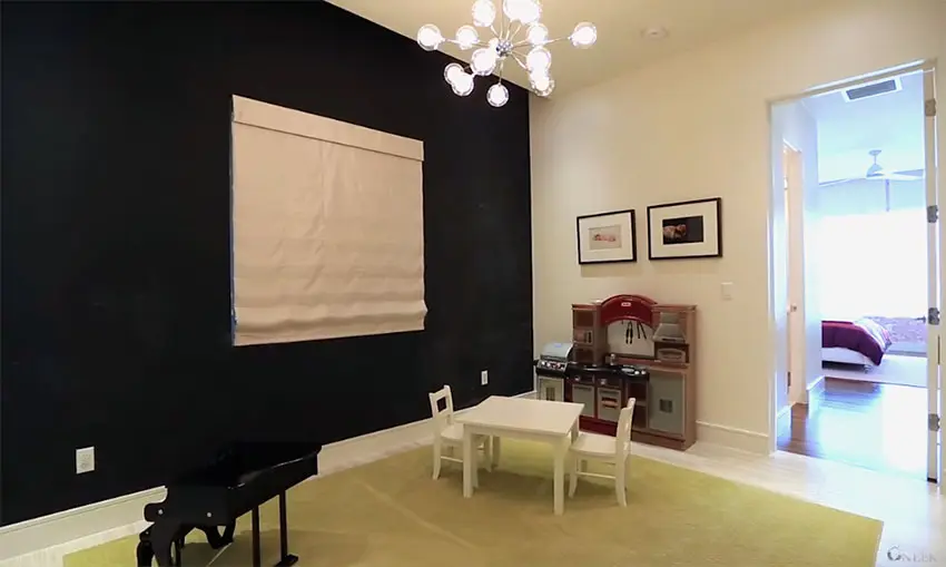 Child's playroom with chalk wall and mini outdoor kitchen and small kids piano