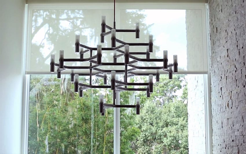 Close up view of custom modern chandelier with outdoor view backdrop