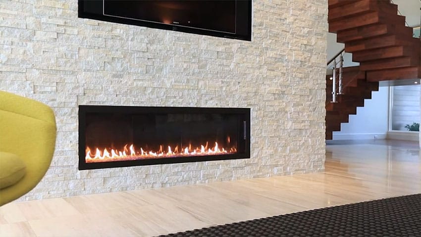 Close up view of modern gas fireplace in stone wall