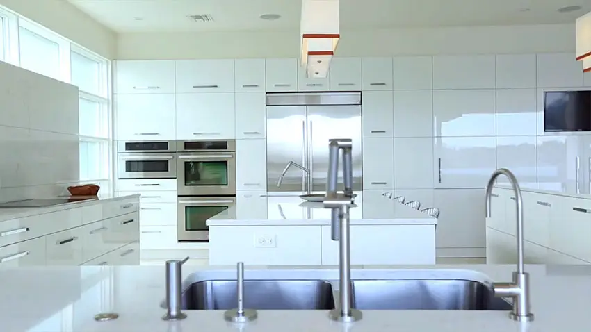 Close up view of white modern kitchen with eat in dining breakfast bar 