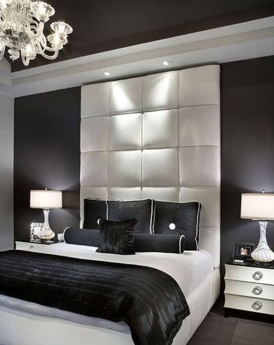 Contemporary bedroom with black walls and white bed frame and tufted headboard