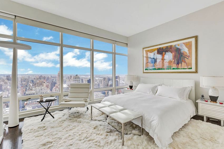 Contemporary bedroom with city views, shag carpet and white decor