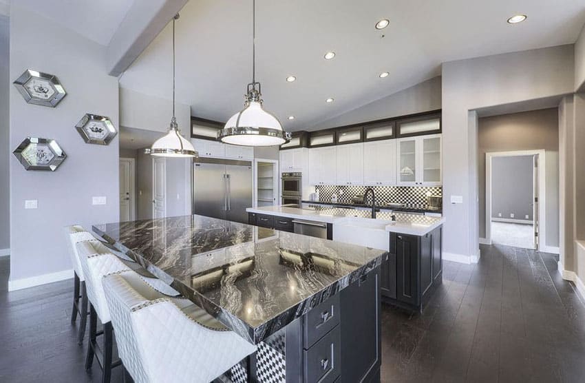 Dark cabinet kitchen with black granite counters and cooking island 