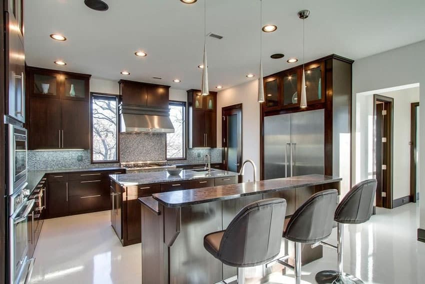 Kitchen with breakfast bar island and satin nickel mini pendant lights