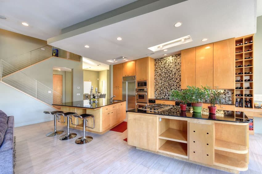 Contemporary kitchen with light color cabinets and two islands, one for dining and one for food prep