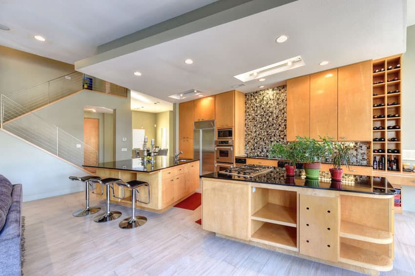 Kitchen with light color cabinets with islands for dining and food prep