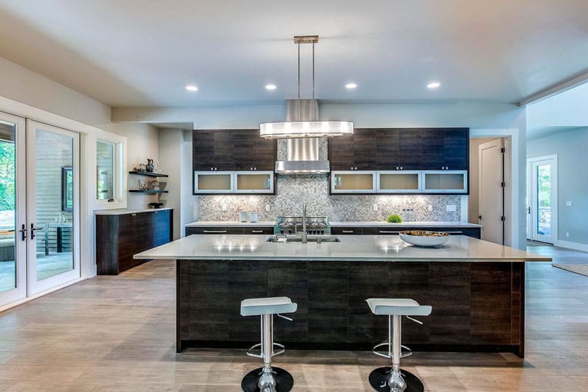 contemporary kitchen with meridian gray quartz counter island with chrome bar stools and brushed beige marble tile floors