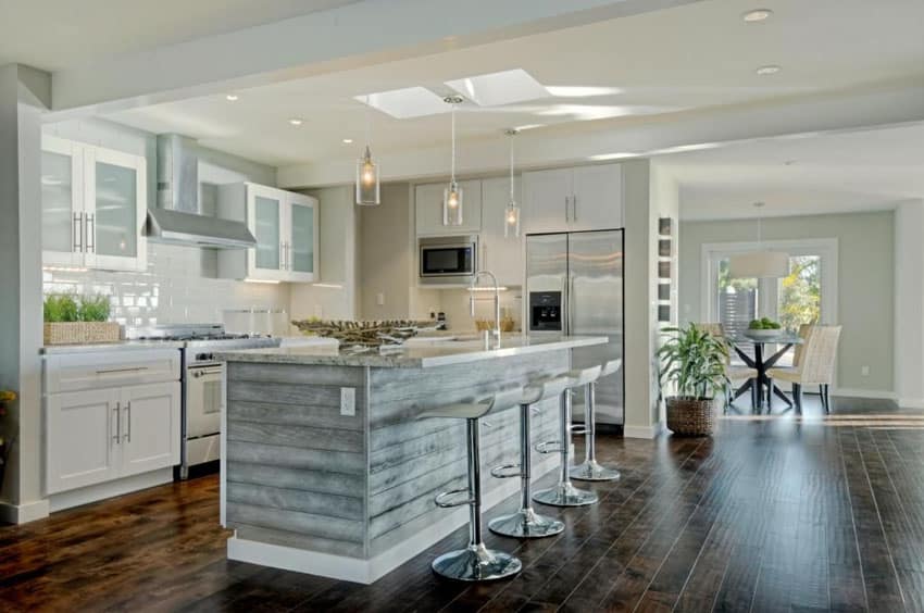Contemporary kitchen with pebbled glass cylinder pendant lights and subway tile backsplash