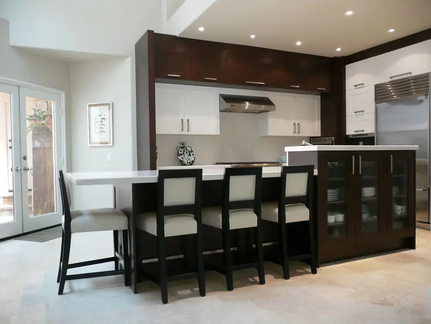 Contemporary kitchen with quartz breakfast bar and white and brown cabinets