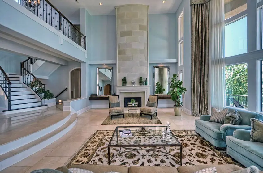 Contemporary living room with blue color theme, high ceilings and fireplace