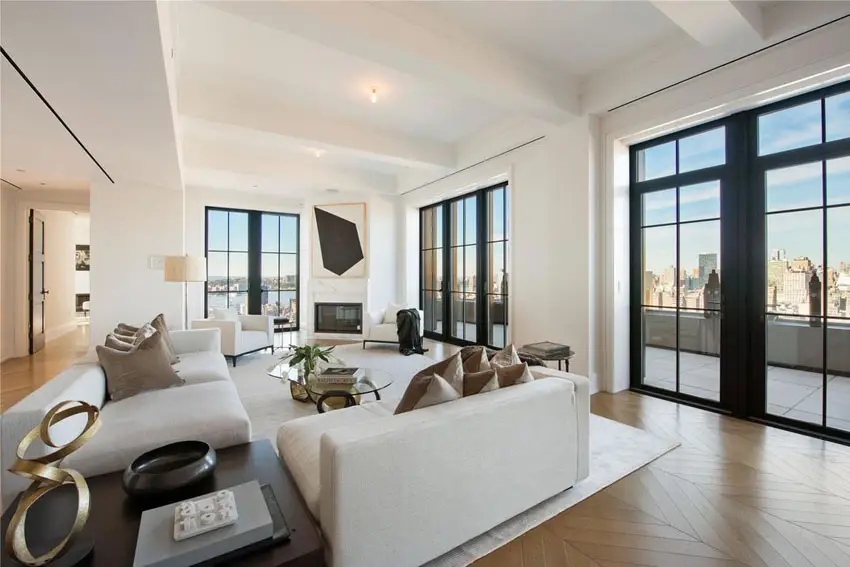 Contemporary living room with city views, wood floors and painted beam ceiling