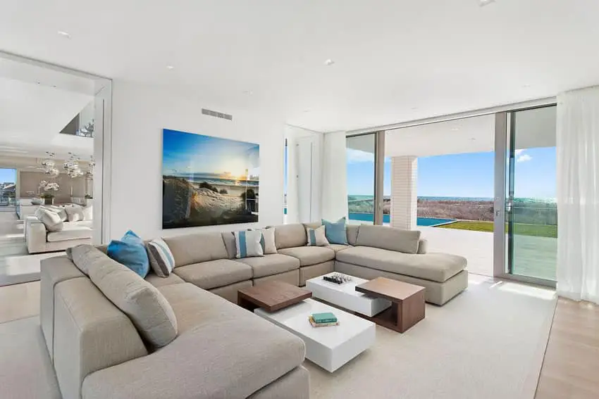 Contemporary living room with large sectional sofa and sliding glass doors to pool patio
