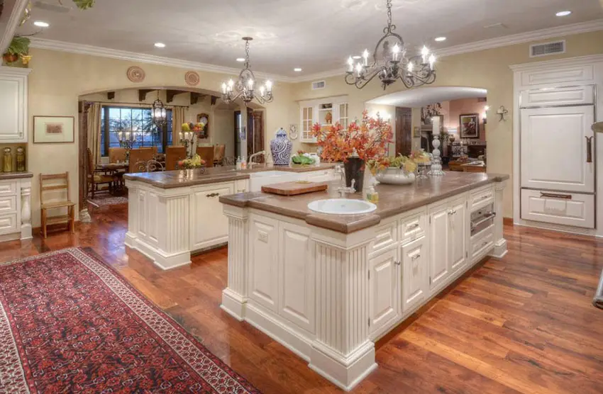 Country kitchen with two large islands and rustic chandeliers