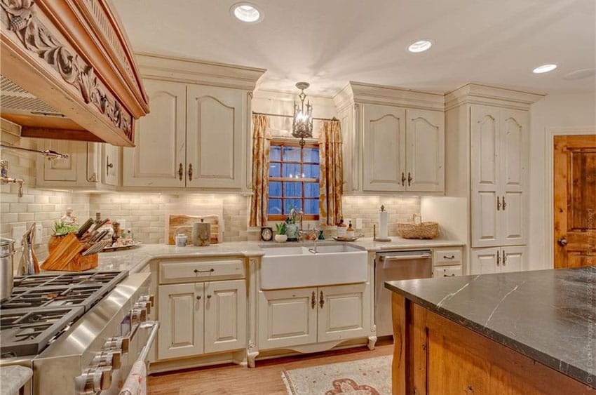 Kitchen with black soapstone counter and farmhouse style wash basin