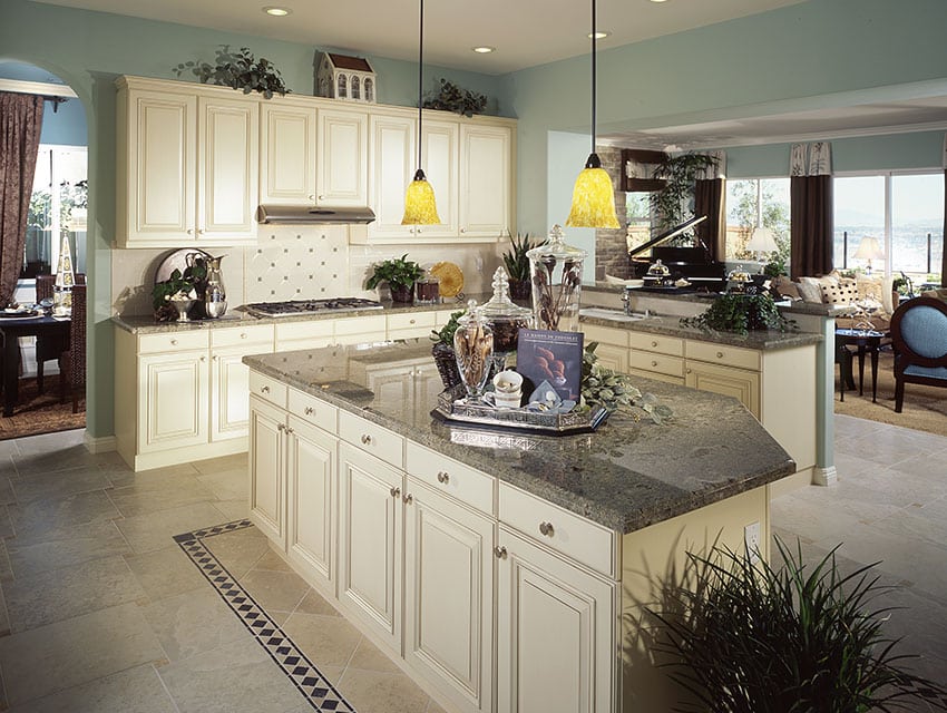 Cottage style kitchen with white backsplash and grey ganite countertops