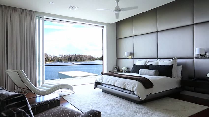 Custom designed modern master bedroom with lake views and lounge chair