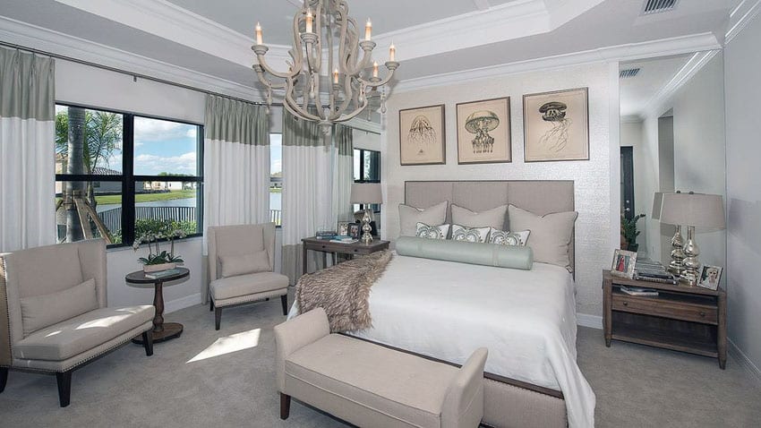 Decorated bedroom with contemporary chandelier and tray ceiling
