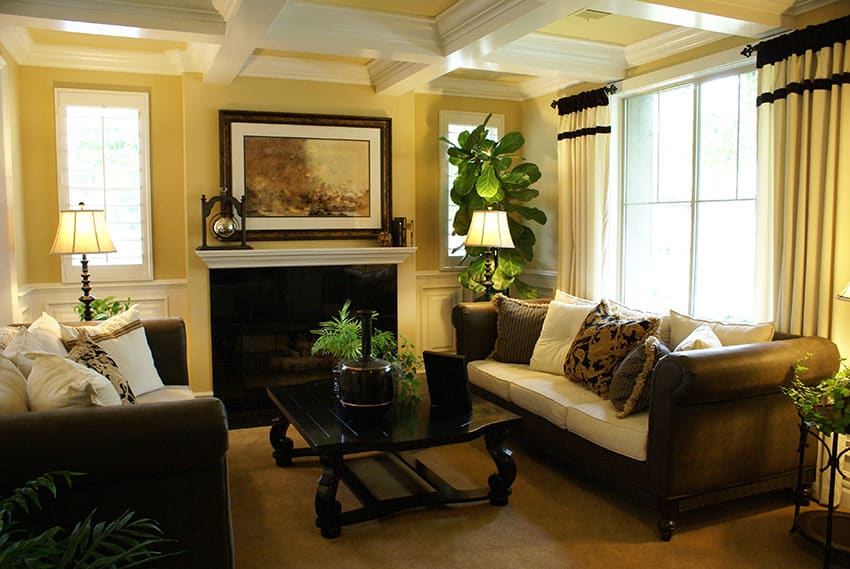 Decorated formal yellow living room with coffered box ceiling